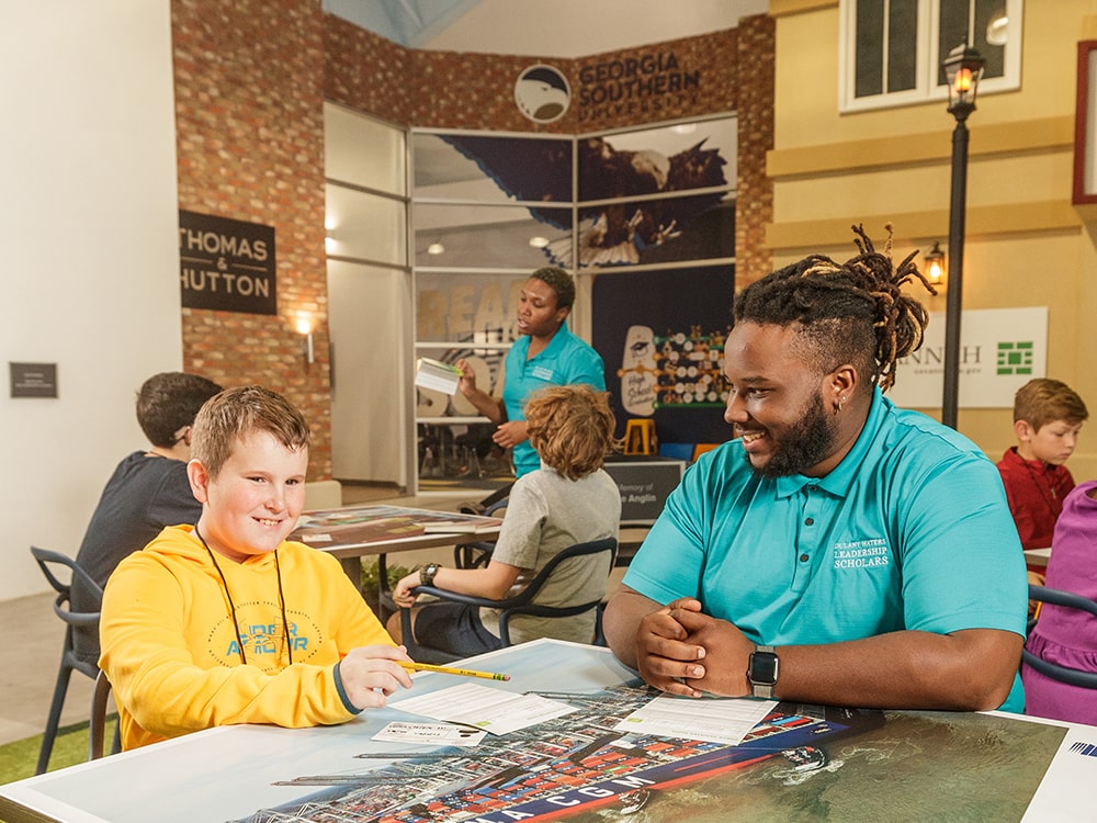 Georgia Southern intern mentoring a middle school student at the Junior Achievement Colonial Group Discovery Center.