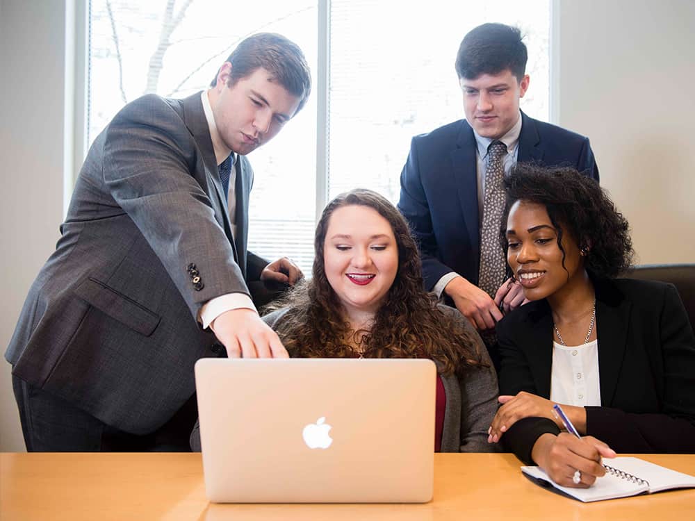 Georgia Southern students gather in business professional attire for an information systems and analytics pitch.