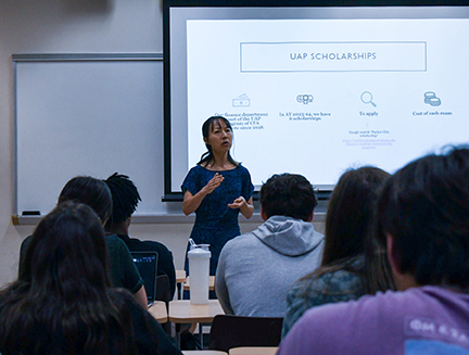 Instructor presenting UAP scholarships to Georgia Southern students during a classroom lecture.