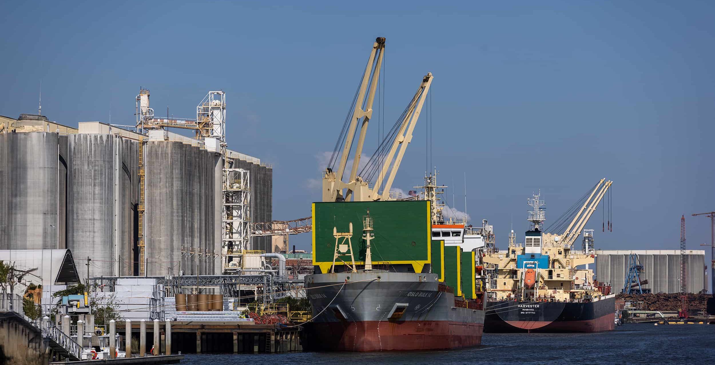 A harbor with cargo carriers shows the practical impact of shipping and logistics supply chain.