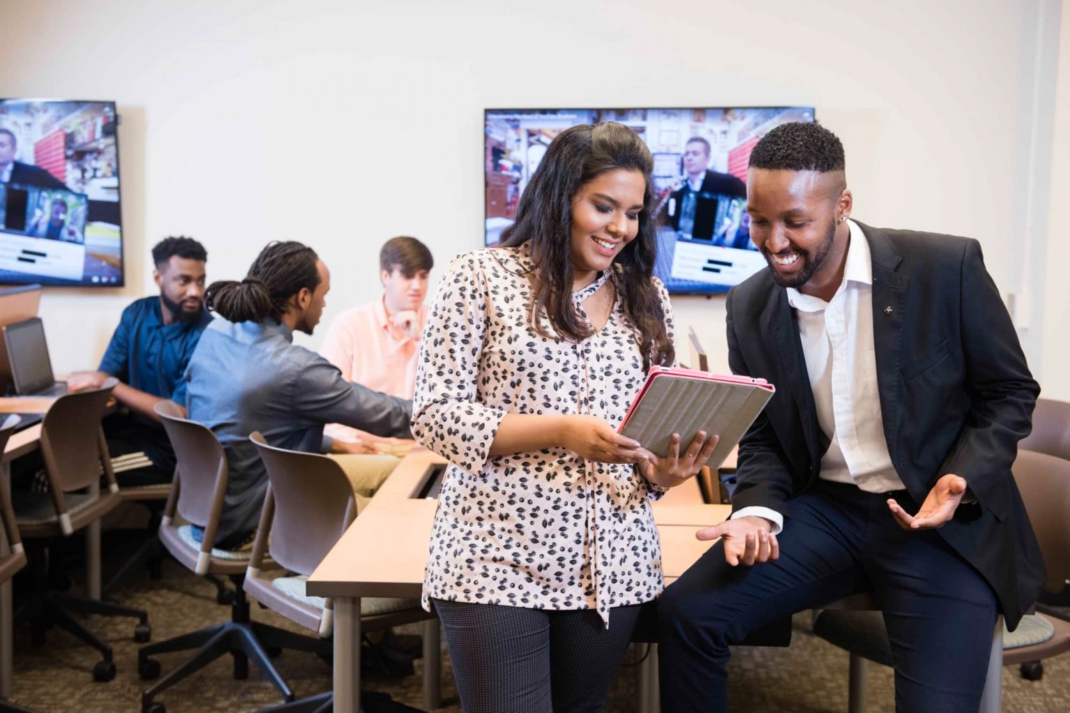 Enterprise systems students collaborating and using a tablet during a class at Georgia Southern University.
