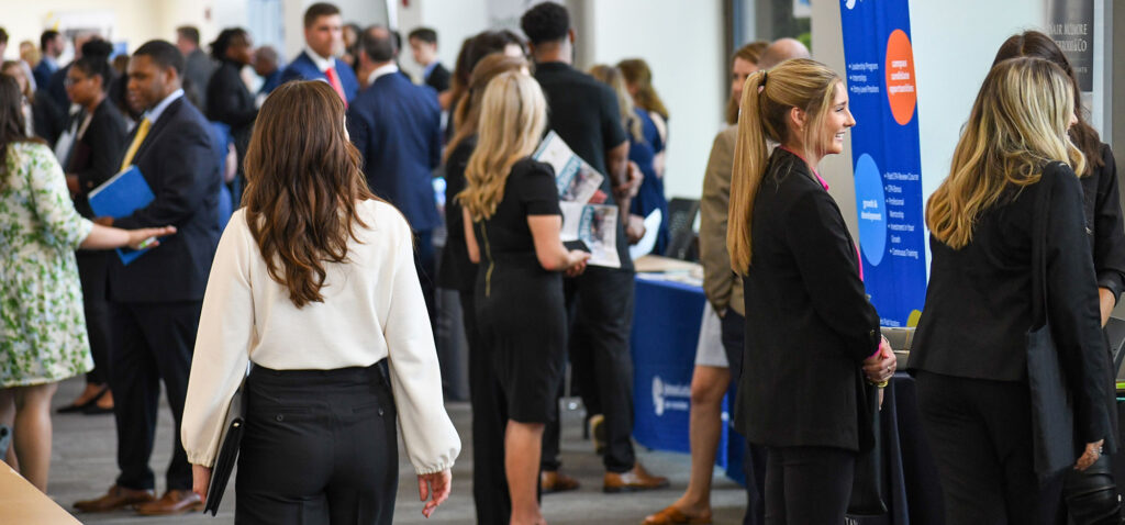 A group of Georgia Southern Business students stroll through a career fair for future success in the professional world.