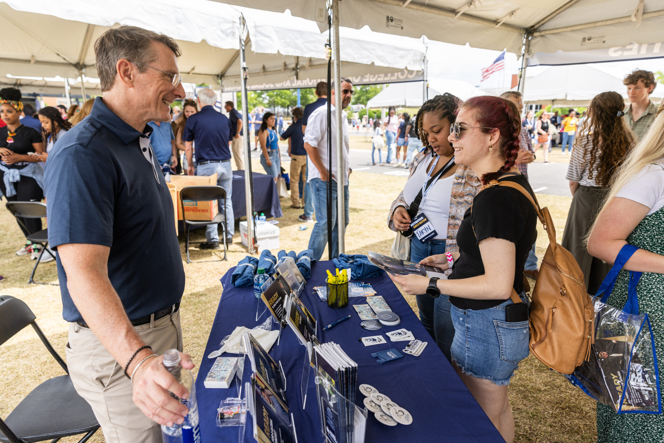 Georgia Southern students browse tables and converse with faculty for information and free merchandise.