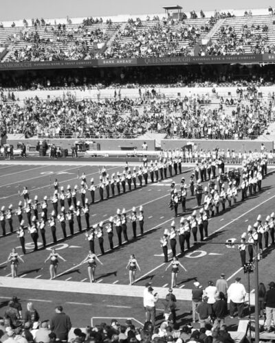 Black and white historical photo of Georgia Southern marching band and cheer leaders during halftime of a football game.
