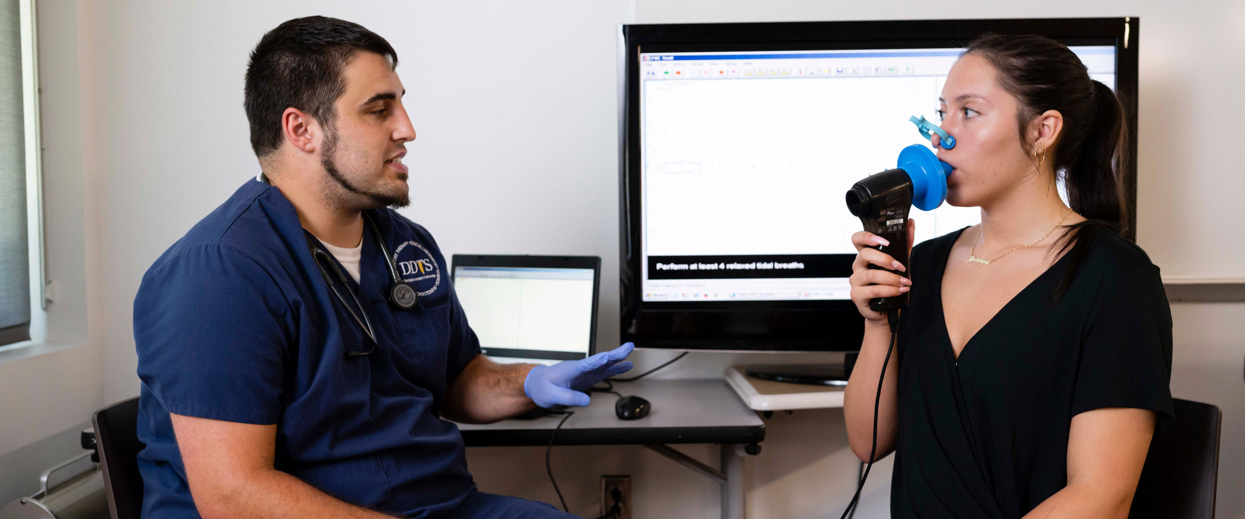 Two students from Georgia Southern's B.S. in Respiratory Therapy program practice assessing patient breathing with industry-standard tools.