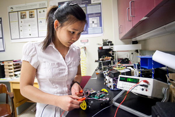 Georgia Southern student conducts electrical current research analysis in lab.
