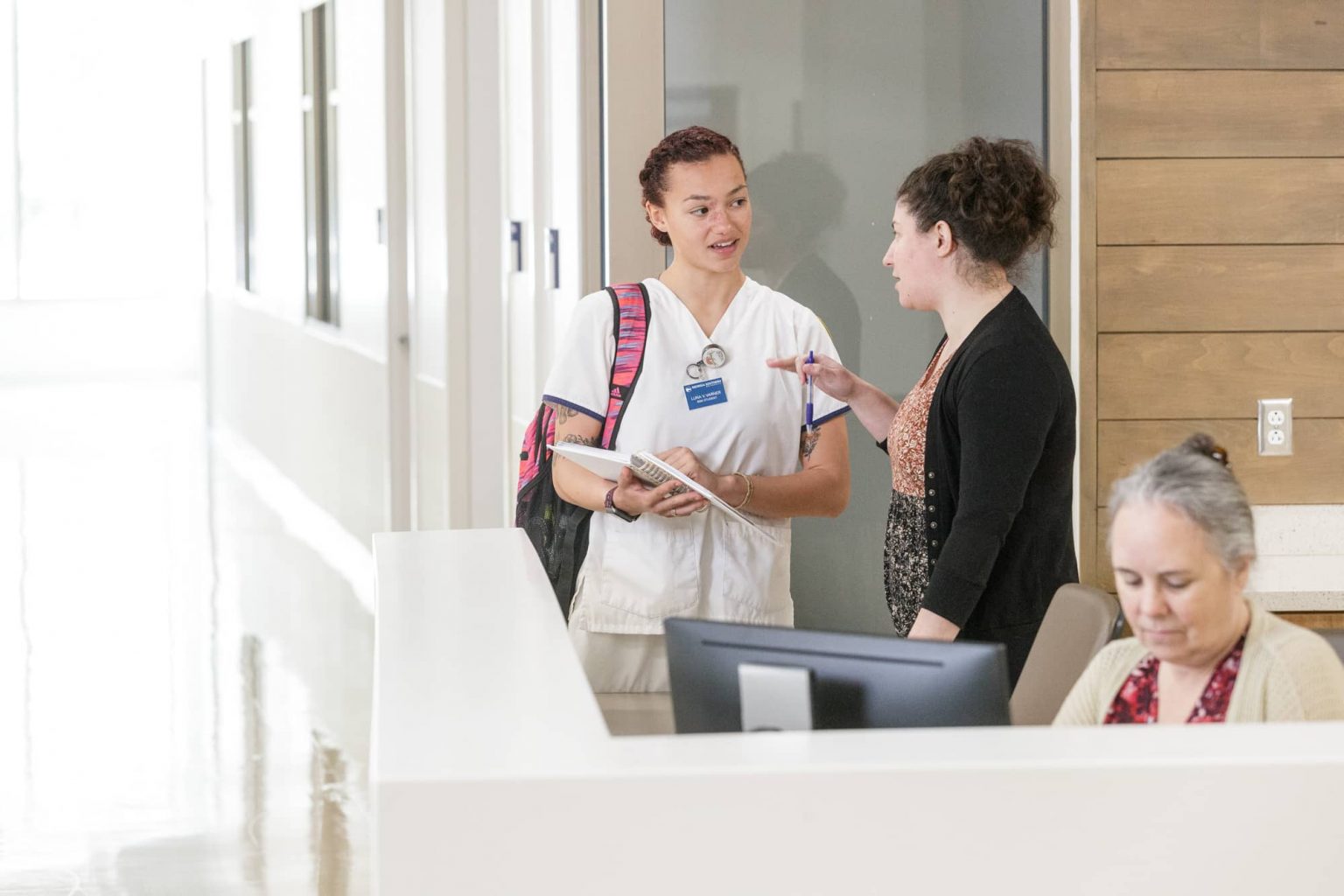 A Georgia Southern nursing resident receives instructions before doing her first rounds on the hospital floor.