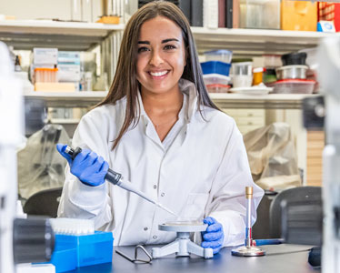 A student in Georgia Southern's Health Sciences, BHS Program pipes liquid onto a measuring device.