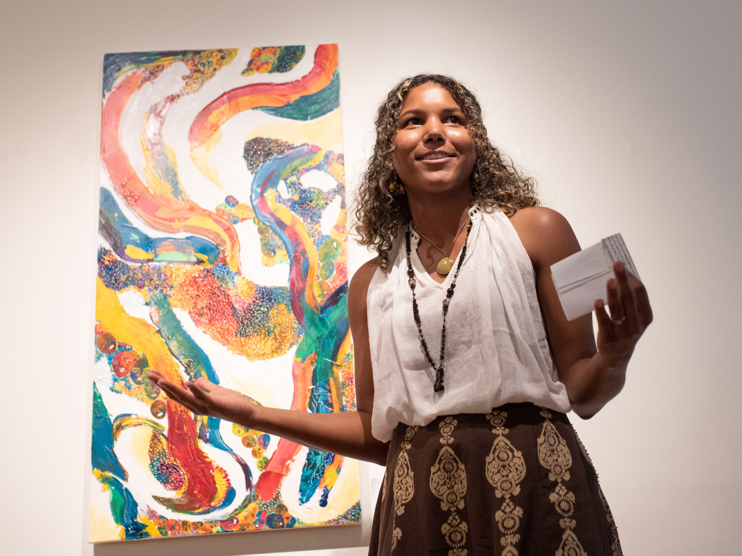 Georgia Southern art student confidently showcasing a feature art display, on exhibit at gallery