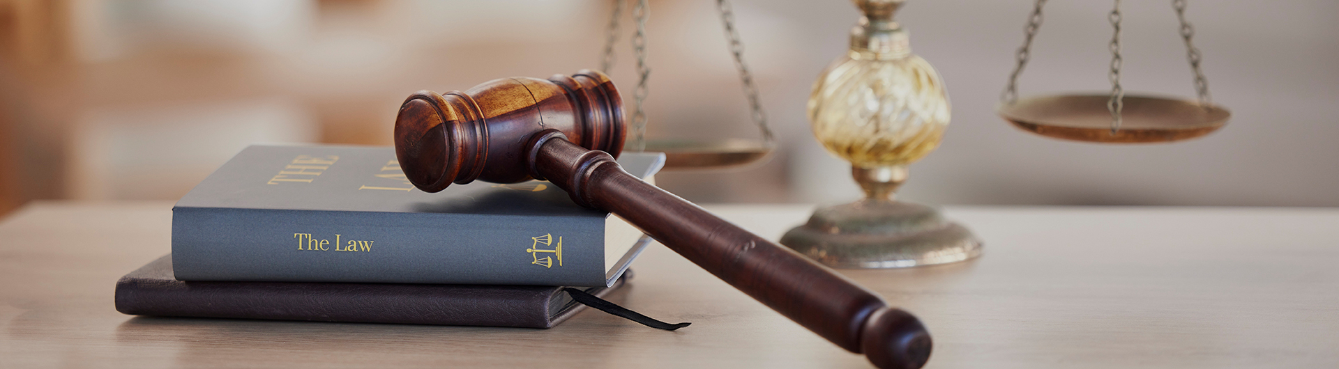 Background, gavel and law books with scales on table of judge, attorney and court trial. Closeup of legal hammer, notebook or desk of lawyer in constitution, equality and human rights of fair justice.