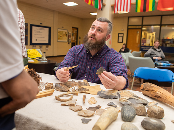 A Georgia Southern student explais the diverse artifacts he is examining during a workshop