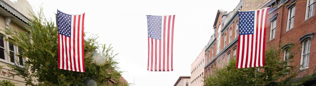 American Flags hang between buildings.