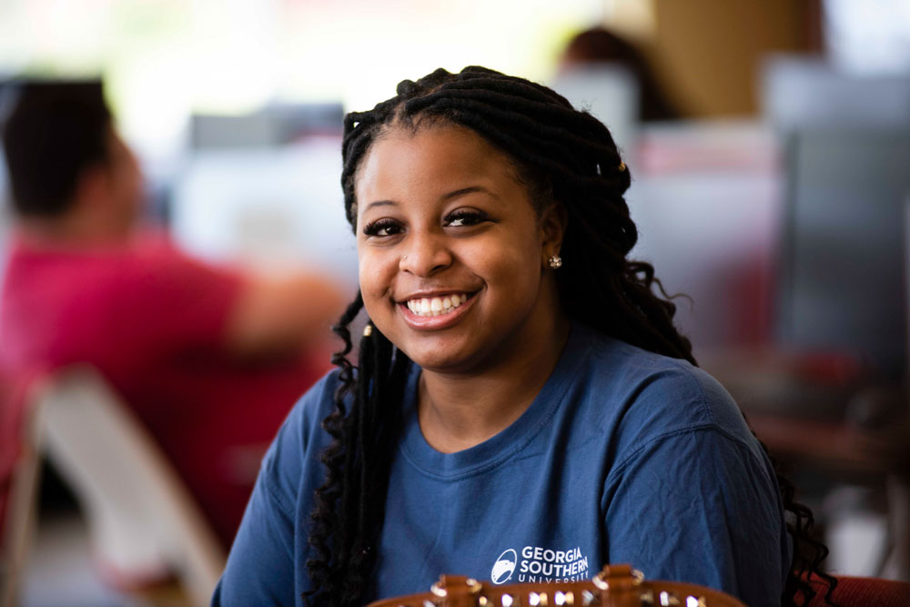 A student from Georgia Southern's M.S. in Mathematics program smiles in a crowd