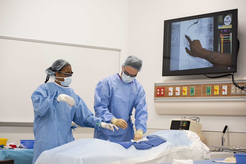 Two adult learners at Georgia Southern get hands on training in the medical field in a classroom and hospital setting.