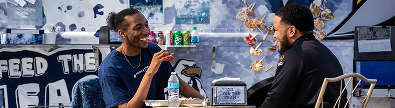 Teo Georgia Southern students socialize and share a meal together after getting information from the visitor center.