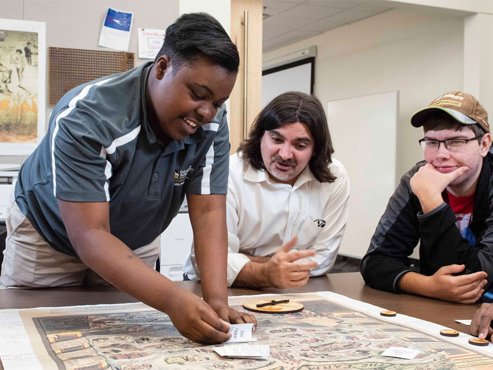 Georgia Southern students study a historical map together in the BA in History major.
