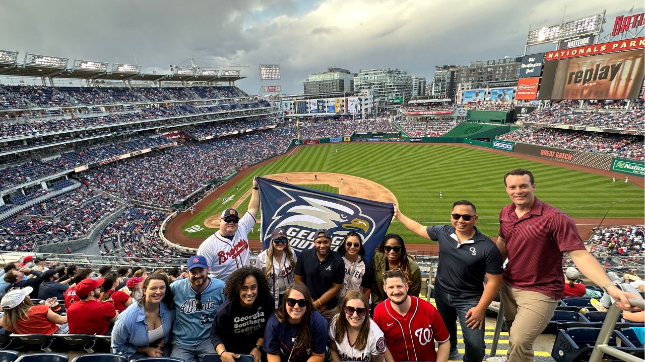 Georgia Southern Alumni in DC attending a Washington Nationals baseball game with flag.