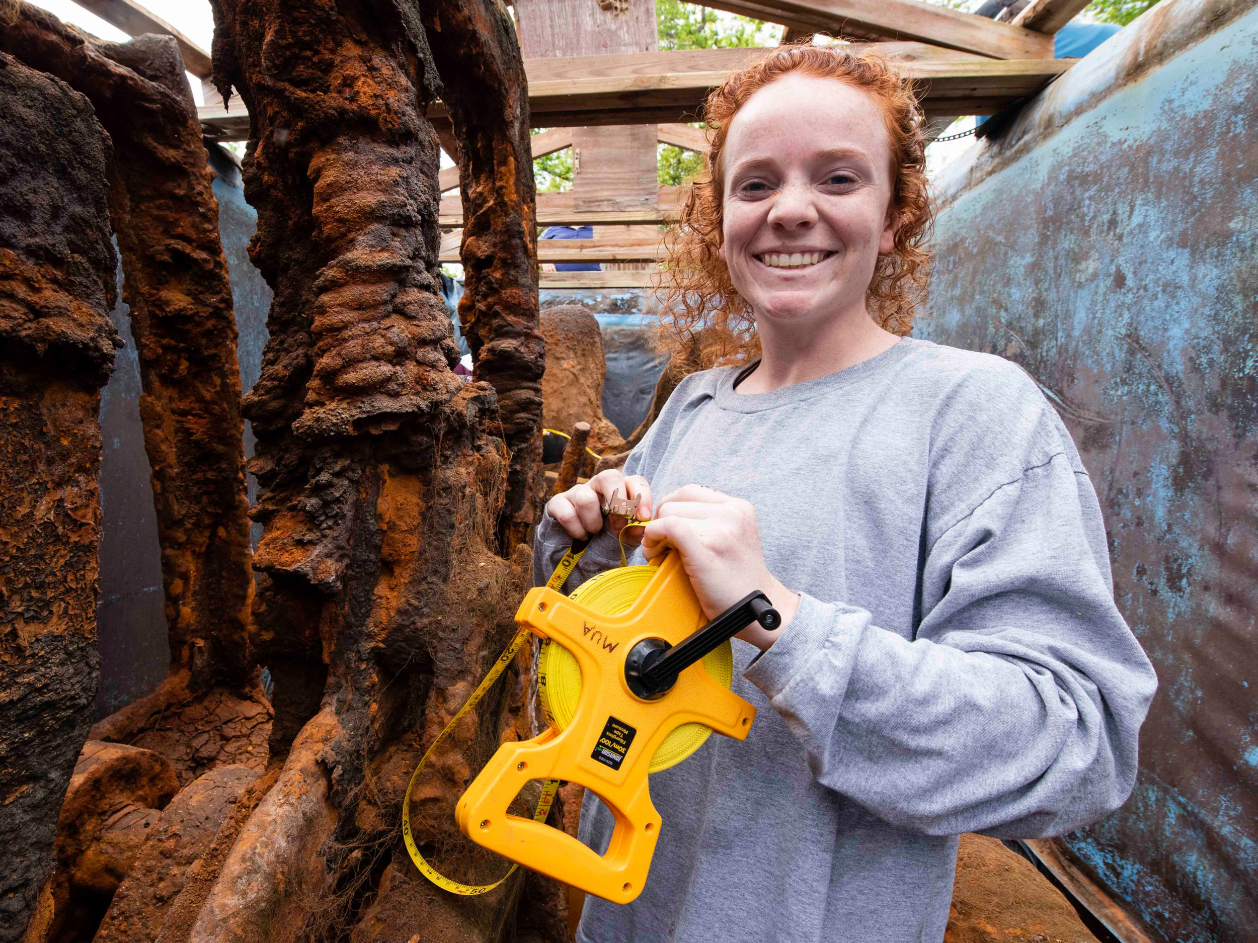 Georgia Southern student in archaeological site, immersed in historical evnironment.