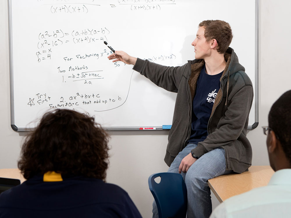 A Georgia Southern student explains how to solve a complex mathematic equation to class.