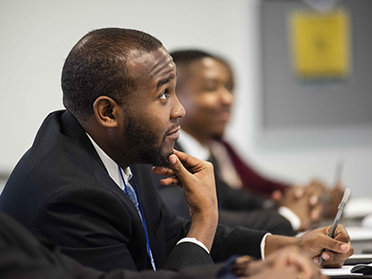 A young professional in the Georgia Southern Criminal Justice Criminology Honors College looks up after being called upon in a lecture.