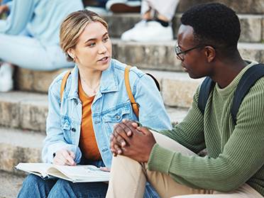 Talking students, black man or woman on stairs, university steps or college campus bleachers for studying research books. Friends, people or notebook in education learning or school exam preparation.