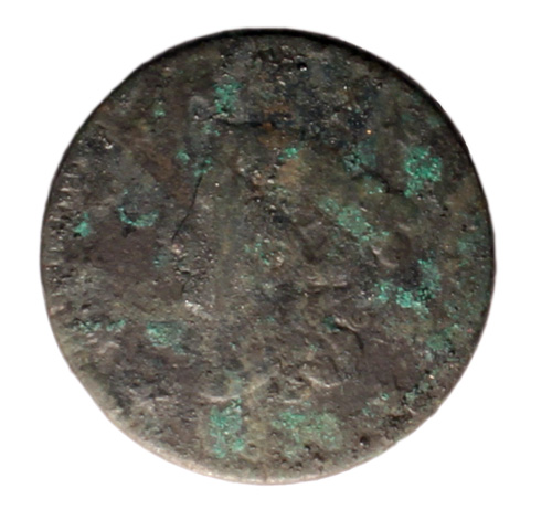 A very corroded copper coin. There is a woman's head with a crown printed on the surface and illegible writing around the edge.