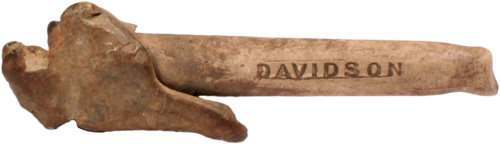 A long cylindrical object with a bulbous mangled end and the word Davidson etched along the cylinder.