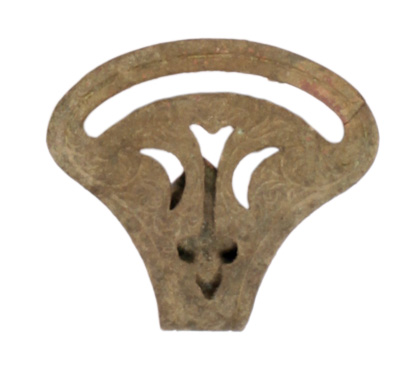 A flat piece of brass pierced with several openings and embossed with a fleur-de-lis.