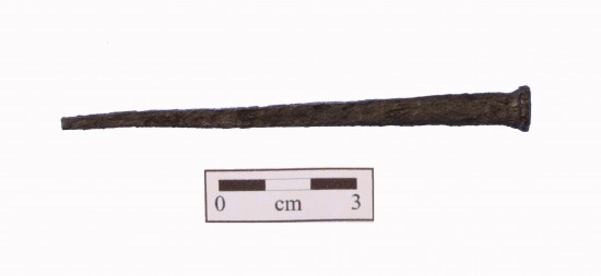 approximately 9 centimeter long nail with a squared and tapered shape.