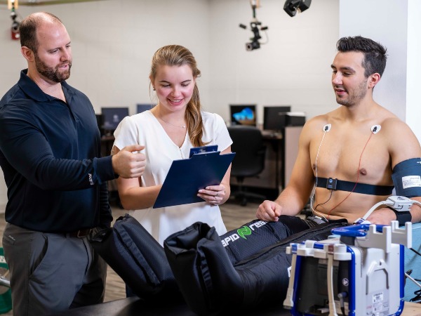 A faculty member instructs a student researcher in evaluating a subject's performance results.