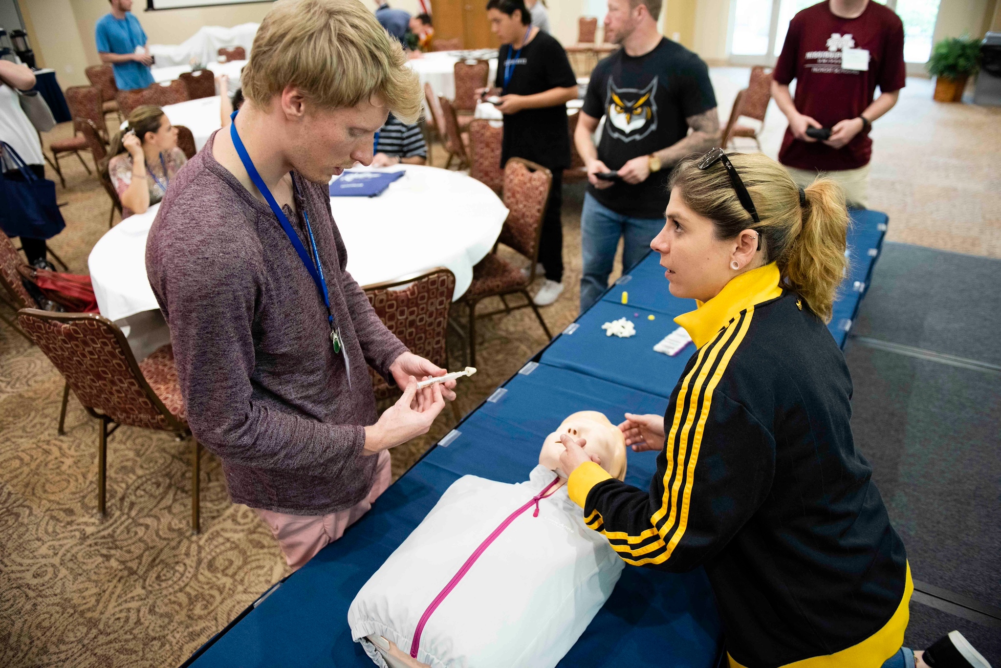 Students interacting with a CPR dummy