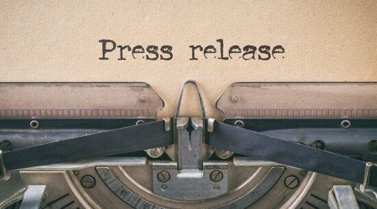 An old-fashioned typewriter with the words Press Release typed on a piece of paper.