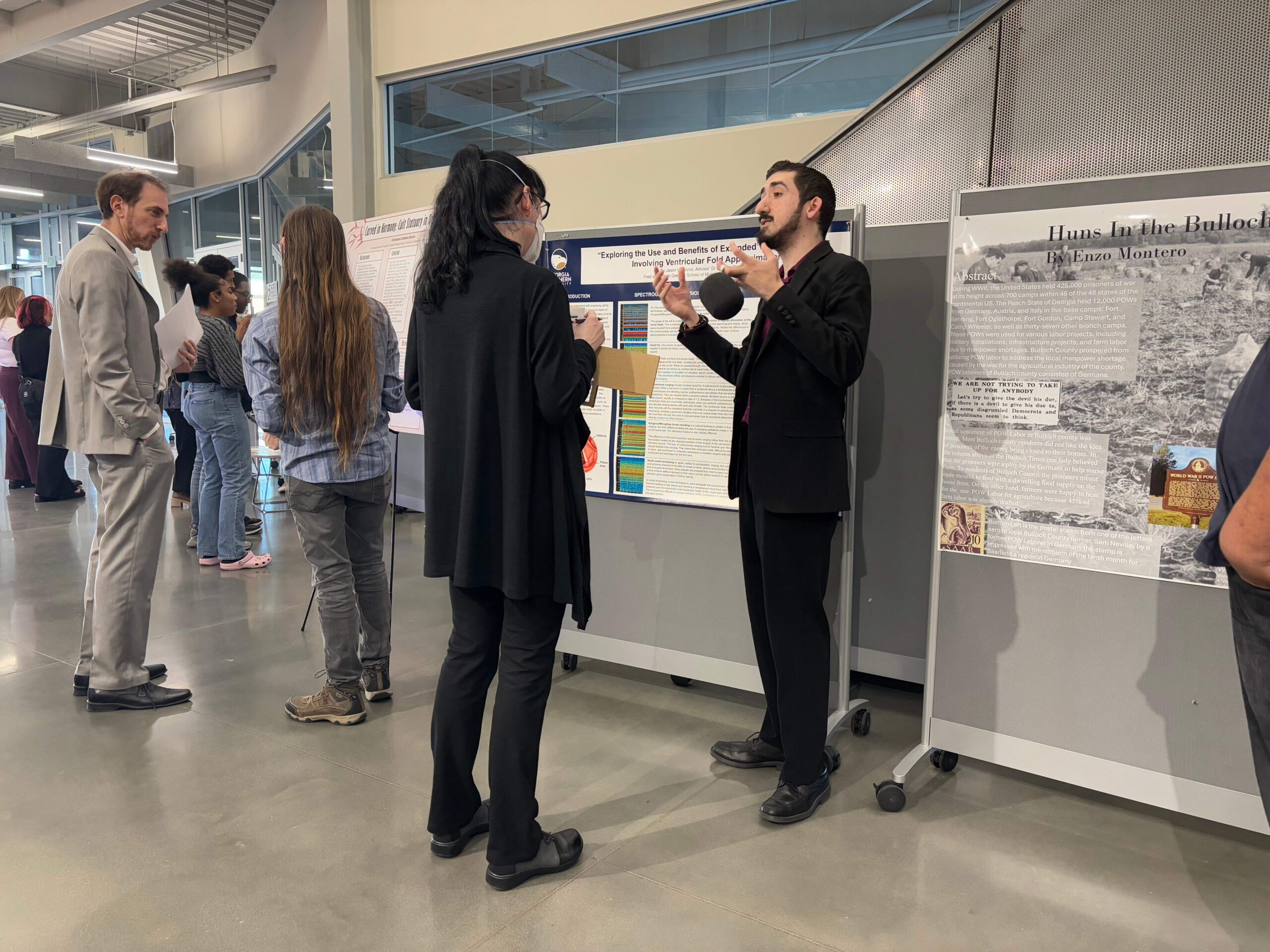 Georgia Southern University students present their research posters to judges during the 2025 CURIO Symposium.
