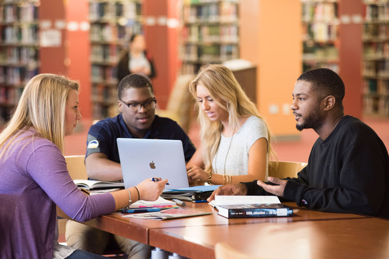 Group of Georgia Southern students studying in library.