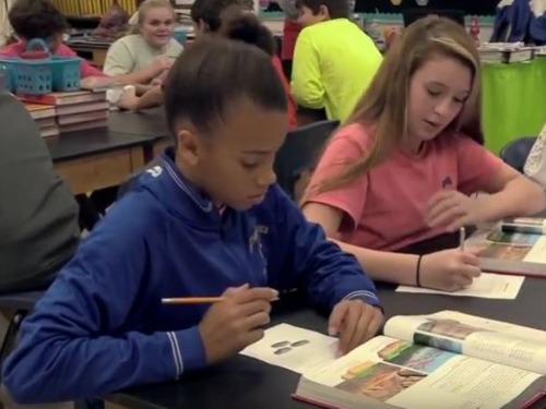 Middle school students in a classroom.