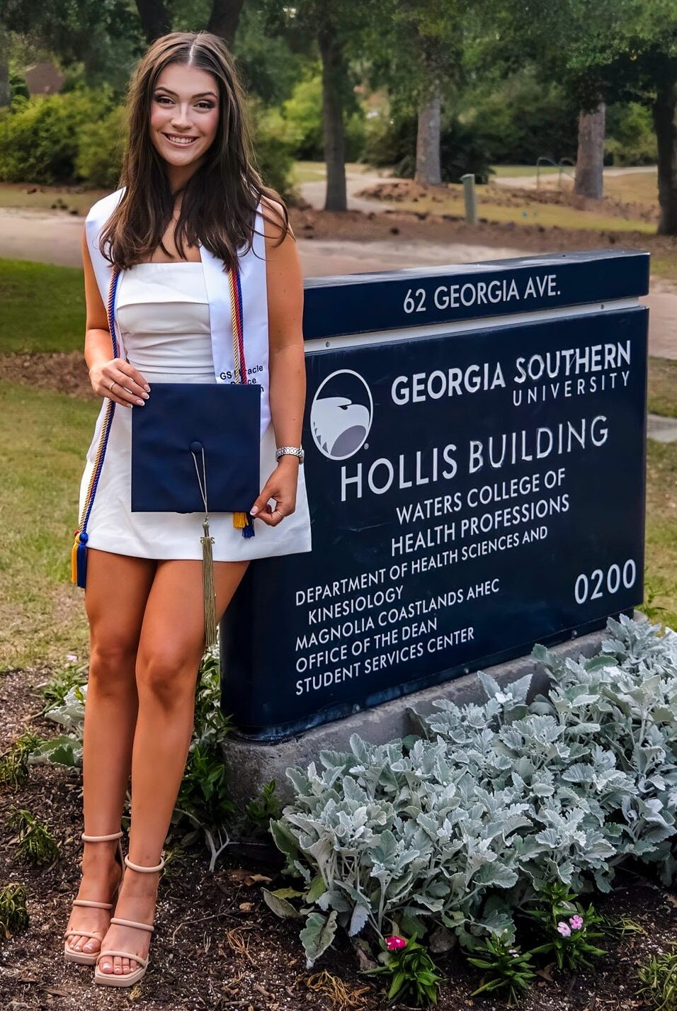 Georgia Southern University graduate Ava Geyer poses next to the Hollis Building sign
