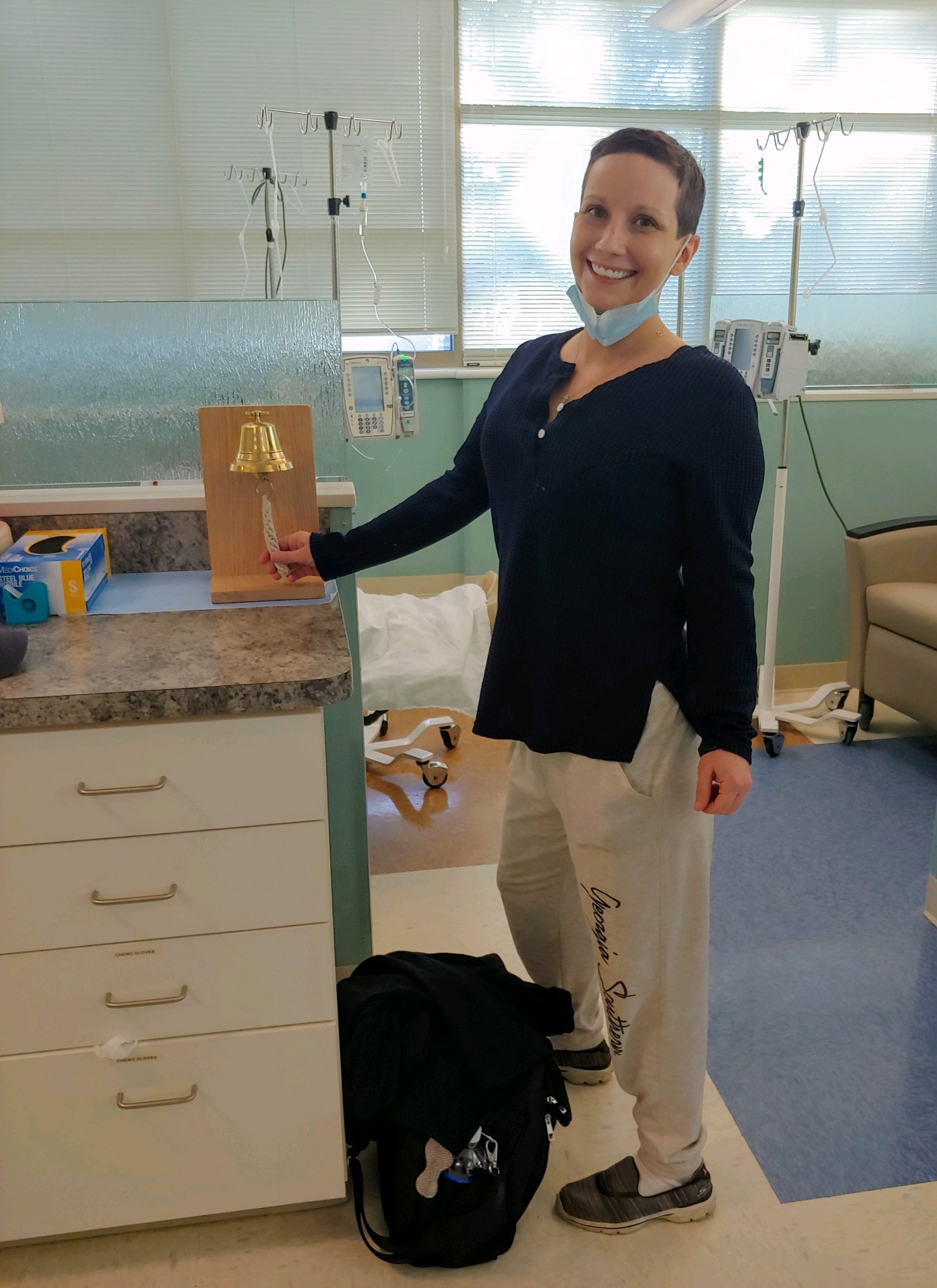 Kristin Bailey rings a bell to signify her completion of chemotherapy treatments.