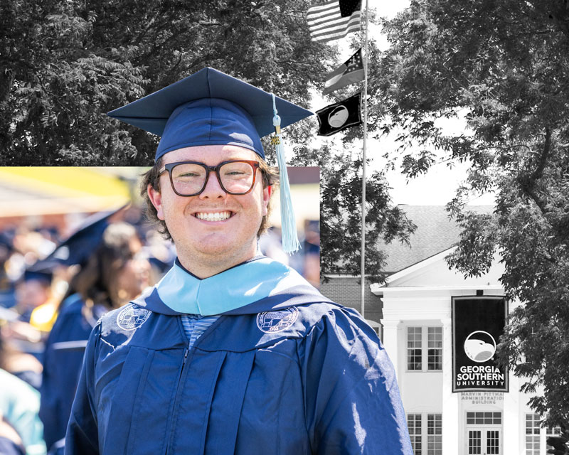 A male Georgia Southern graduate wearing a cap and gown at graduation.