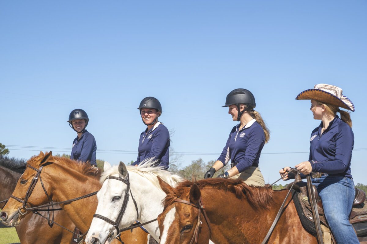 A group of Georgia Southern students ride horses together in teh CRI Equestrian Club.