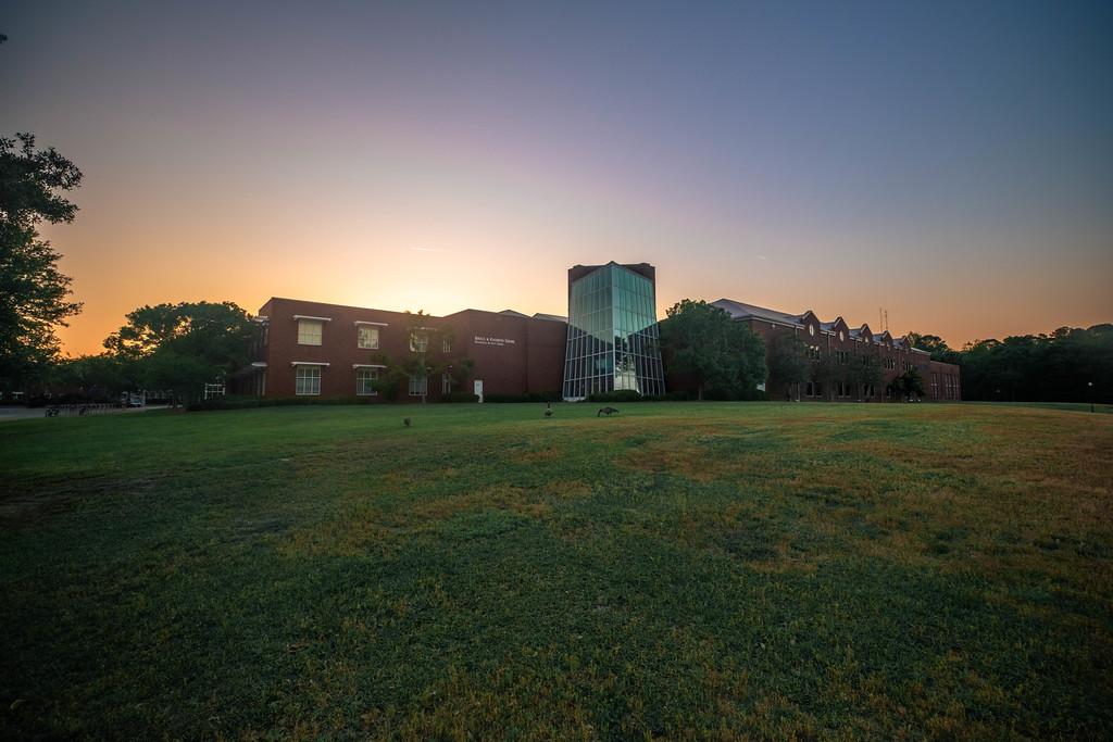 Image of the CRI recreation intramural center with green lawn at sunset.