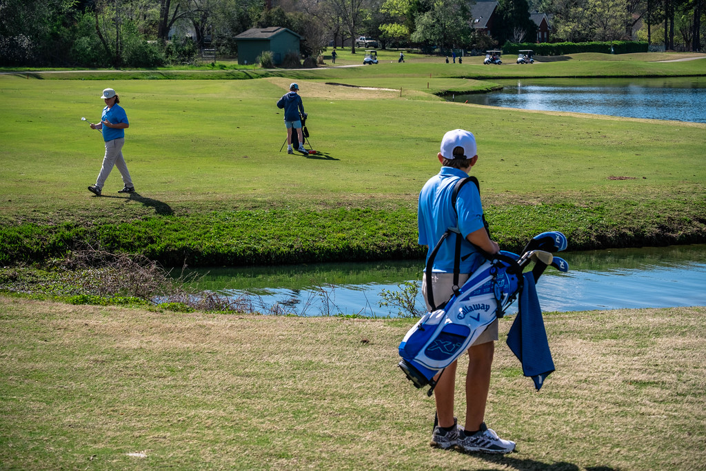 Georgia Southern youth golf camp on course with clubs.