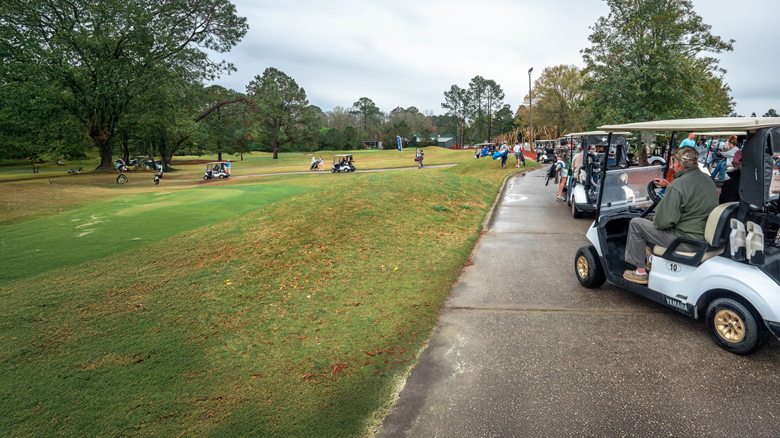 A group of Georgia Southern golfers enjoy the green in golf carts.