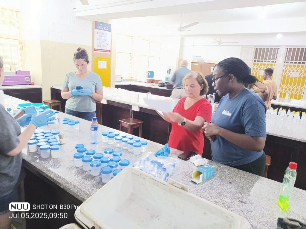 Two students measure random blood sugar levels using the glucose meter kits while others consult about the preliminary findings.
