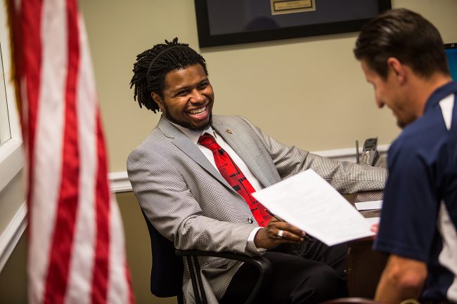 Justin Williams,military advocate coordinator, works with a fellow student in the Military Veteran Student Center 