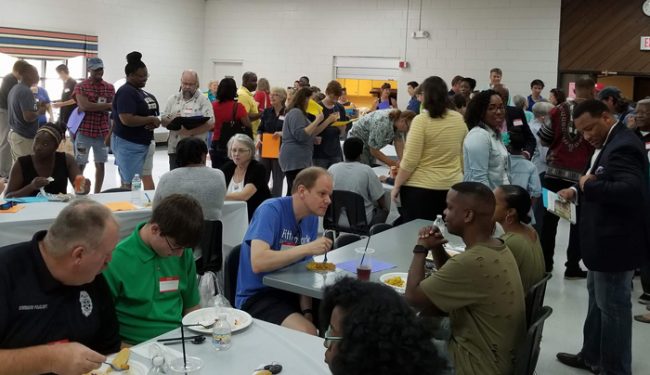 Bridging the Gap event with people gathered, eating together