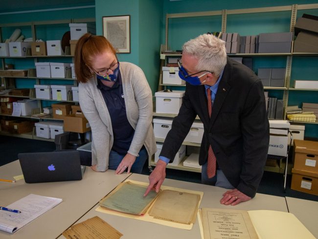 Autumn Johnson, special collections librarian at Zach S. Henderson Library, and Howard Keeley, Ph.D., examine documents in the Lawless papers collection. The documents are housed in the special collections section of the Henderson Library on the Statesboro Campus.