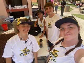 Eagle students at a first aid station while providing care for the 2025 Banana Ball Tournament.