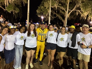 Eagle students pose with a Banana Ball player following an event at Grayson Stadium in Savannah, Georgia.