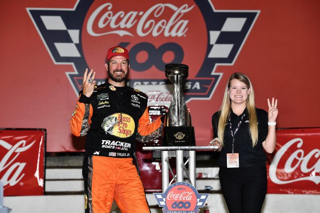 Megan Leben poses for a picture with NASCAR driver Martin Truex Jr. after his win at the Coca-Cola 600 at Charlotte Motor Speedway. Leben interned with Truex's team, Joe Gibbs Racing last summer.
