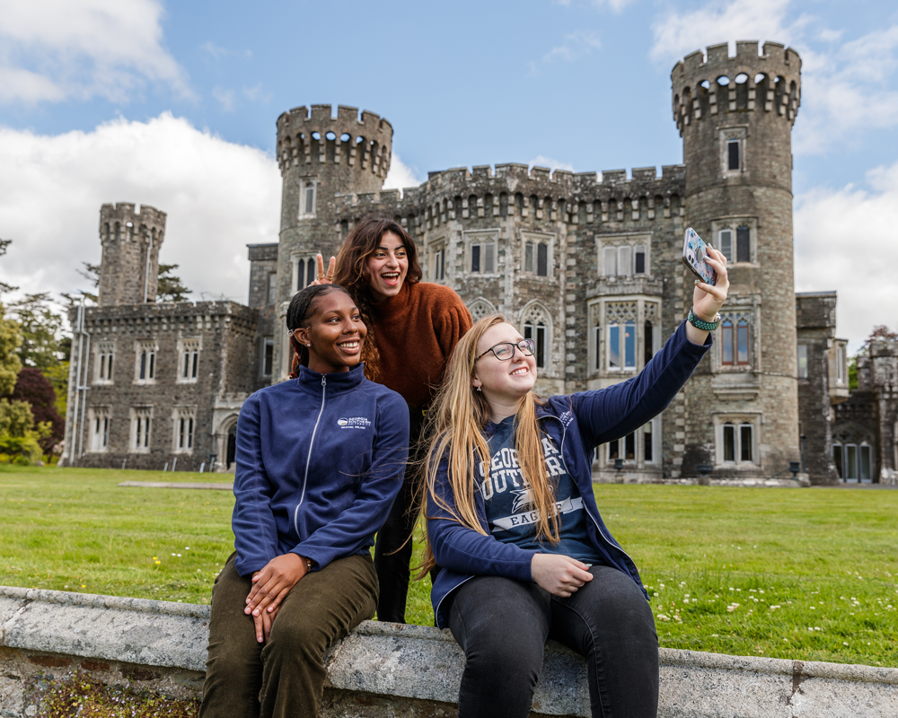 Georgia Southern study abroad students gather for a group selfie in front of a castle near Wexford, Ireland.